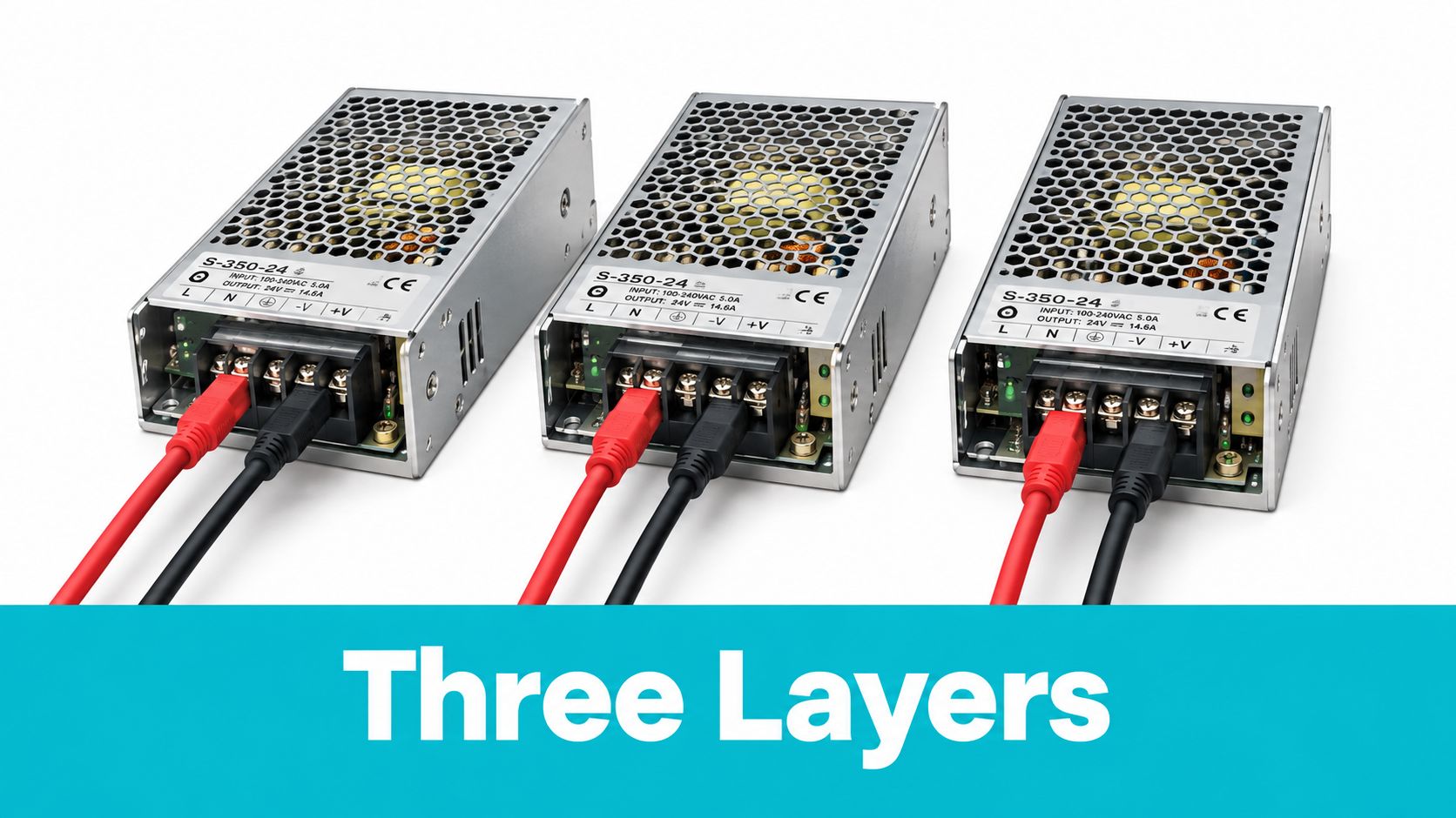 Three industrial power supply units aligned side-by-side with red and black wires connected to their terminals.